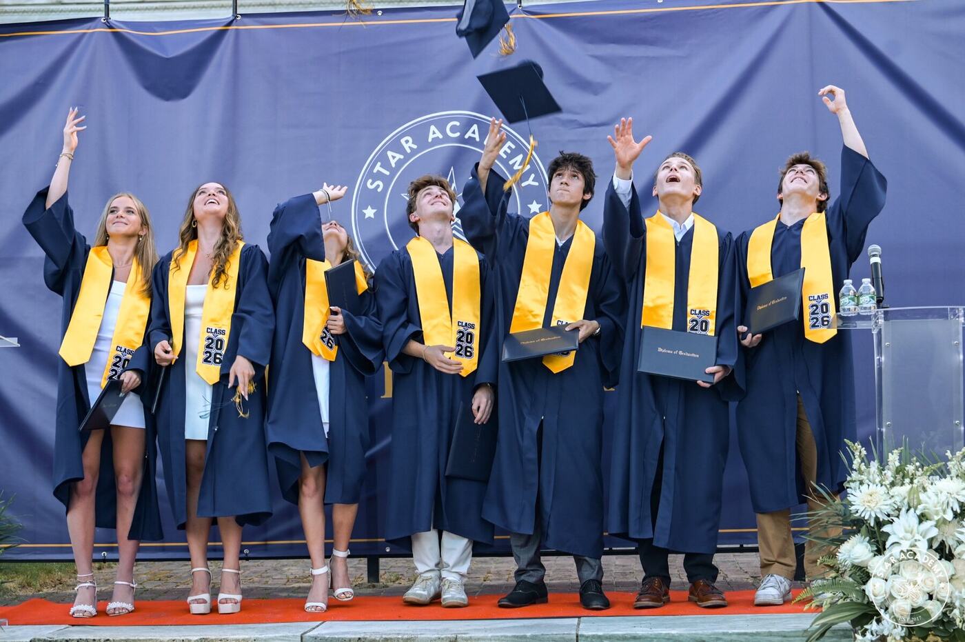 Graduates tossing their caps